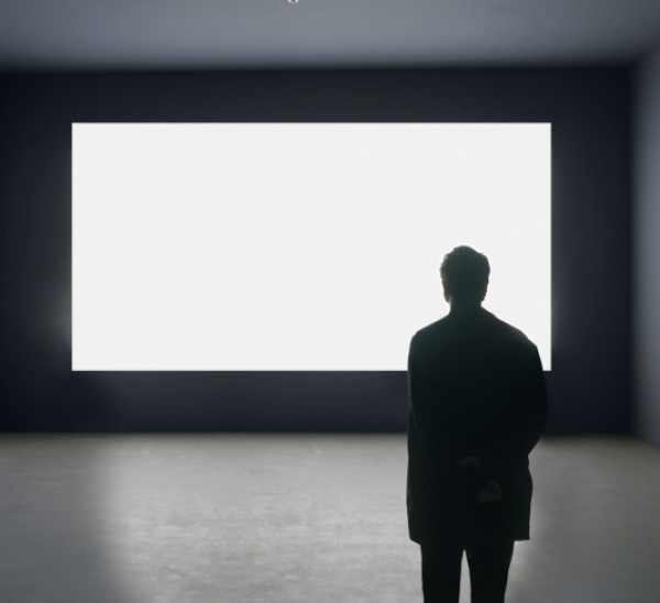 Alfredo Jaar facing \"Lament of the Images,\" 2002. Courtesy of the artist.