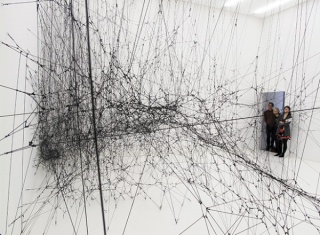 Tomás Saraceno, 14 Billions (Working Title), 2010. Elastic black rope, hooks, 8,330 x 7,630 x 5,000 mm. Courtesy of Bonniers Konsthall, Stockholm, Sweden