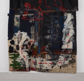 Oscar Murillo, violent amnesia, 2014-2018. Graphite, oil, oil stick, grommets and stainless steel on canvas and linen. 300 x 164 x 15 cm. Courtesy the artist. Photograph: Matthew Hollow