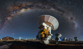 Like a celestial blanket the Milky Way forms an arc high above the antennas of the Atacama Large Millimeter/submilimeter Array.  Credit: A. Duro/ESO